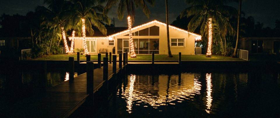 Canal-front dock palms, Palmetto Bay: warm white Christmas lighting idea for Palmetto Bay, FL from Mr. Christmas Lights, (786) 228-6649